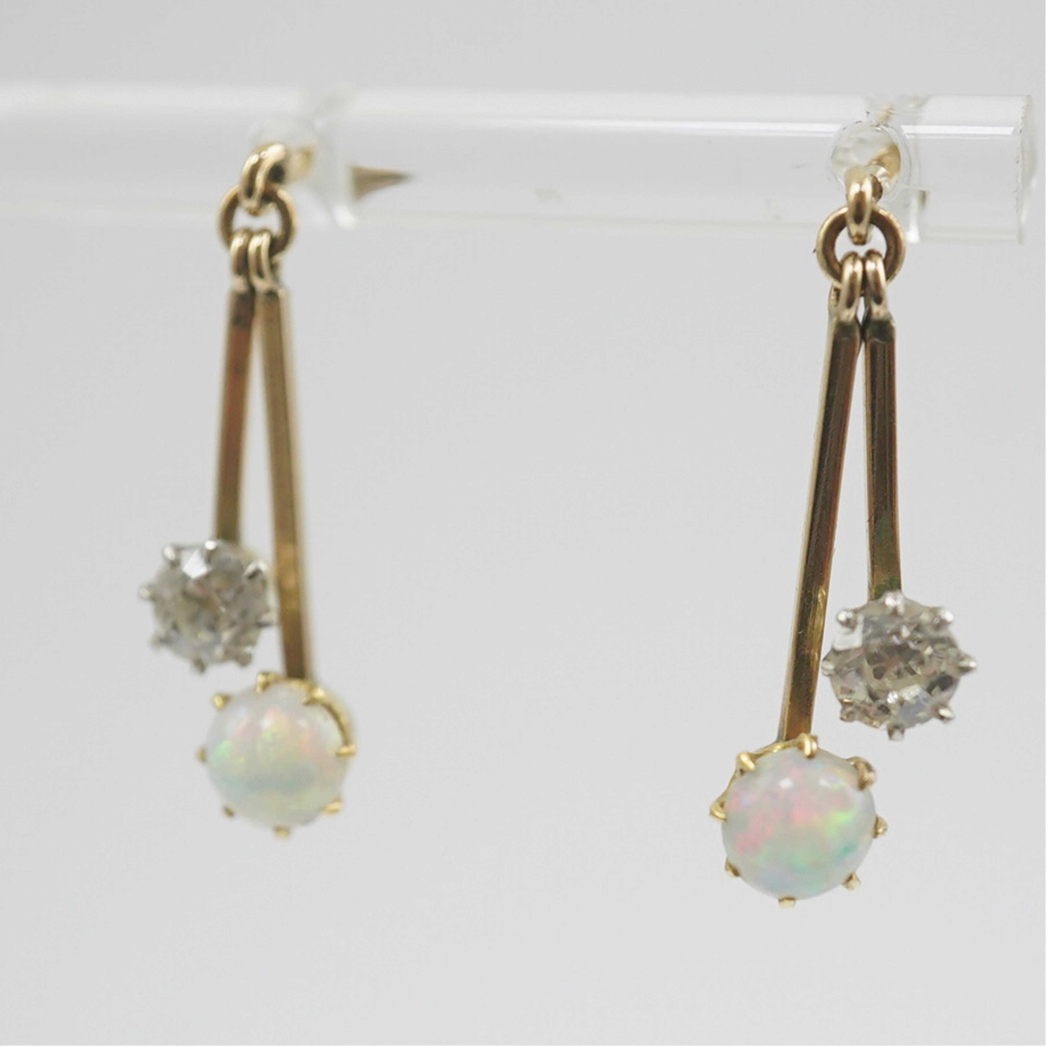 A pair of 9ct gold, white opal and diamond set double drop earrings